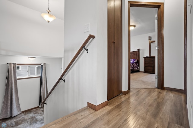 stairway with baseboards and wood finished floors