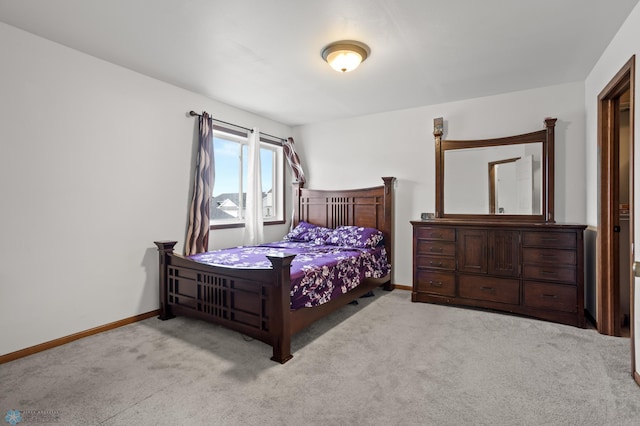 carpeted bedroom featuring baseboards