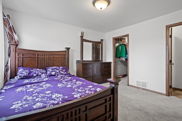 bedroom featuring carpet flooring, a spacious closet, a closet, and baseboards