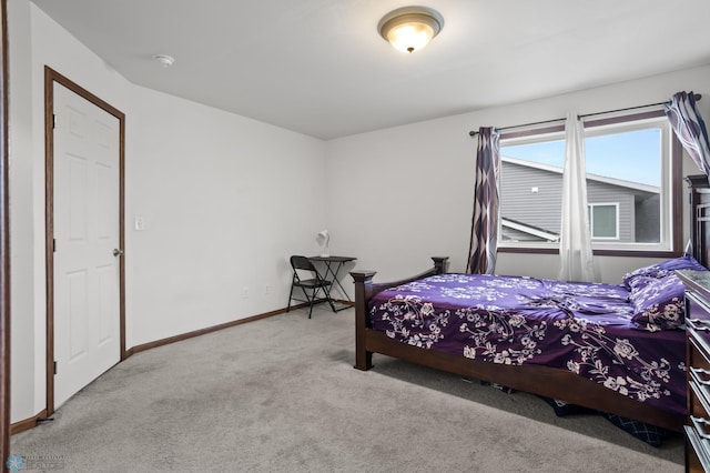 carpeted bedroom featuring baseboards