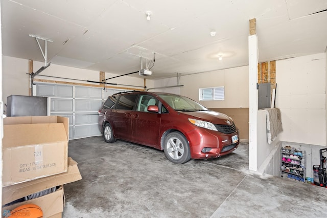 garage with a garage door opener and electric panel