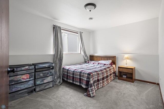 bedroom with carpet floors and baseboards