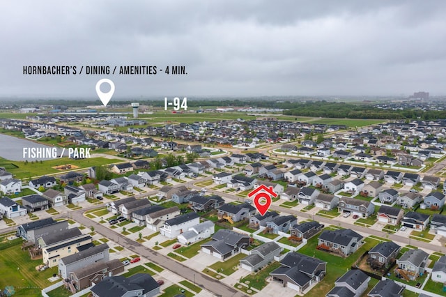 aerial view of property and surrounding area featuring nearby suburban area