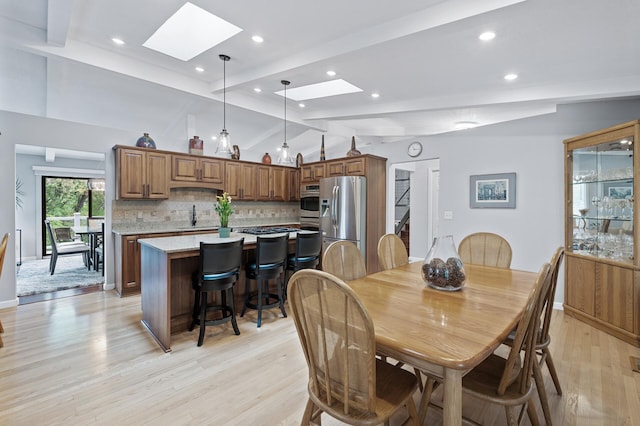 5401 Mount Normandale Dr, Bloomington, MN 55437 - dining room featuring a skylight, light wood-style flooring, recessed lighting, and baseboards