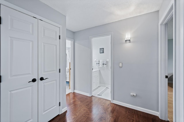 5401 Mount Normandale Dr, Bloomington, MN 55437 - hallway featuring dark wood-style floors, baseboards, and a textured ceiling