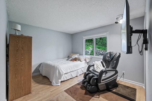5401 Mount Normandale Dr, Bloomington, MN 55437 - bedroom featuring wood finished floors, a textured ceiling, and baseboards