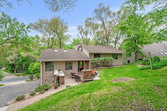 5401 Mount Normandale Dr, Bloomington, MN 55437 - back of property with a patio area, a lawn, a chimney, and a shingled roof