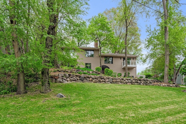 5401 Mount Normandale Dr, Bloomington, MN 55437 - rear view of house with a balcony, a lawn, and a chimney