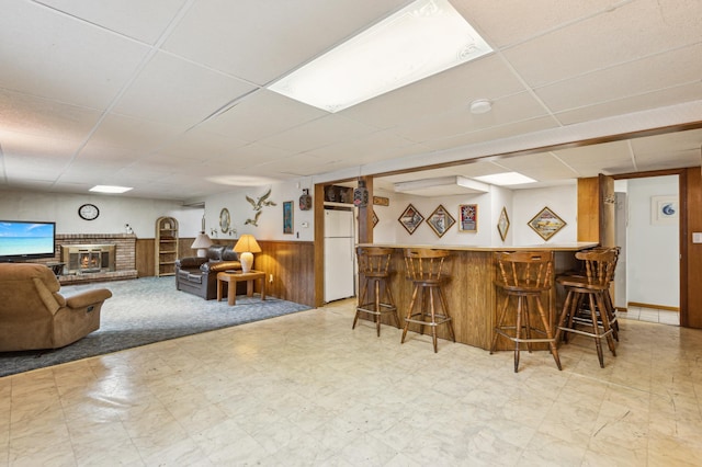 4708 Virginia Ave N, New Hope, MN 55428 - indoor dry bar with a paneled ceiling, light floors, freestanding refrigerator, a wainscoted wall, and wooden walls