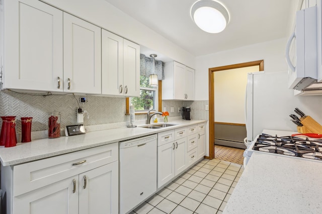 4708 Virginia Ave N, New Hope, MN 55428 - kitchen featuring white appliances, white cabinets, a baseboard heating unit, backsplash, and light tile patterned flooring