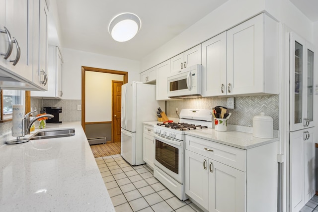 4708 Virginia Ave N, New Hope, MN 55428 - kitchen with white appliances, white cabinets, and backsplash