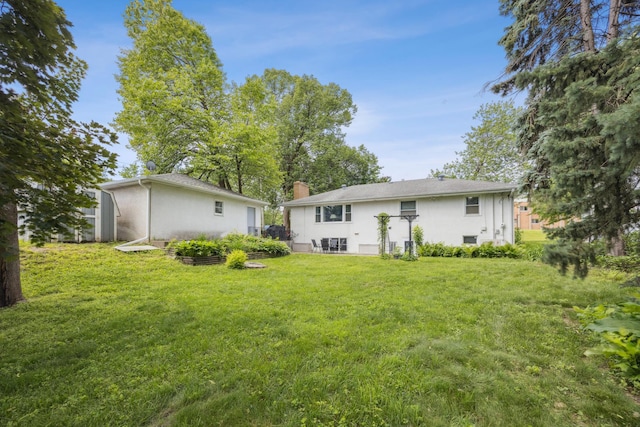 4708 Virginia Ave N, New Hope, MN 55428 - rear view of property featuring a yard, a chimney, and stucco siding