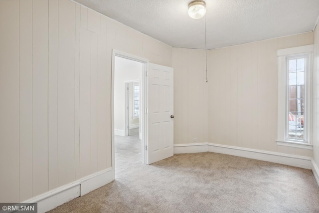 1134 Lincoln St NE, Minneapolis, MN 55413 - empty room featuring carpet floors, a textured ceiling, and baseboards