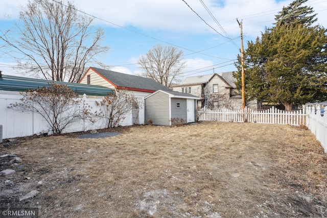 1134 Lincoln St NE, Minneapolis, MN 55413 - fenced backyard featuring a storage unit, an outbuilding, and central AC