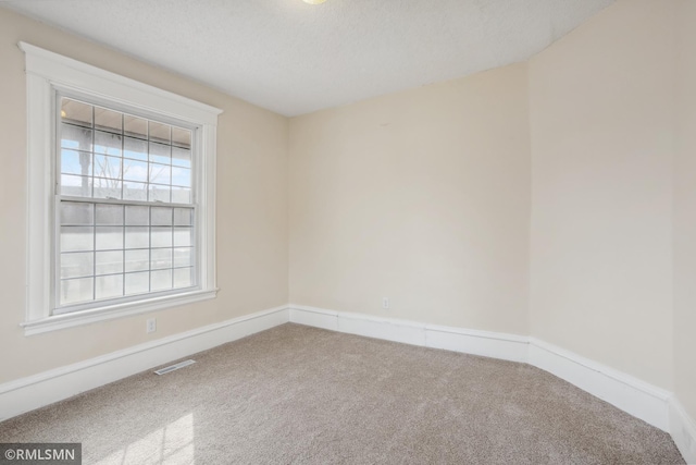 1134 Lincoln St NE, Minneapolis, MN 55413 - unfurnished room with carpet flooring, baseboards, and a textured ceiling