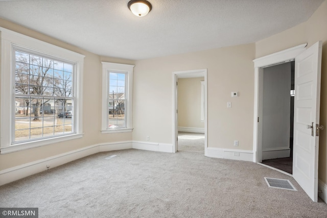1134 Lincoln St NE, Minneapolis, MN 55413 - carpeted empty room with a textured ceiling and baseboards
