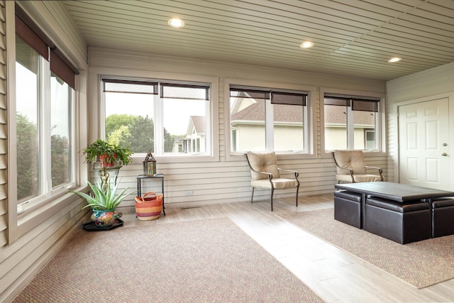 sunroom with healthy amount of natural light, wood finished floors, and recessed lighting