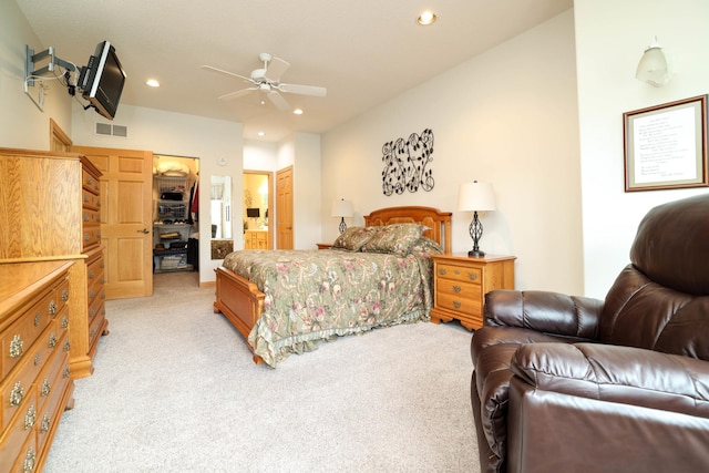 bedroom with light carpet, recessed lighting, a closet, ensuite bathroom, and a walk in closet
