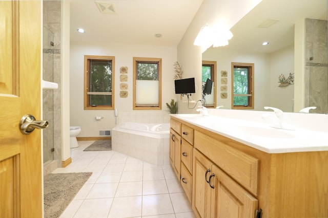 bathroom with tile patterned flooring, plenty of natural light, toilet, a bath, and recessed lighting