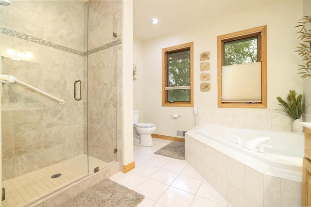 full bathroom featuring a shower stall, tile patterned floors, a bath, toilet, and baseboards