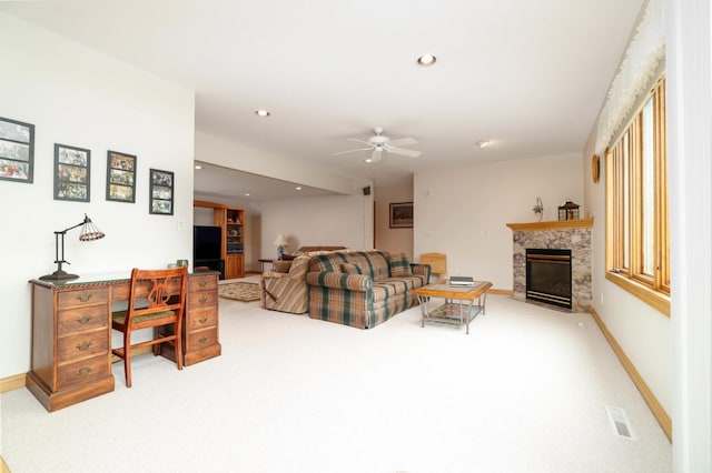 carpeted living area featuring ceiling fan, recessed lighting, baseboards, and a fireplace with flush hearth