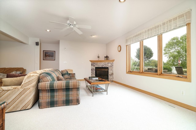 living area with carpet floors, ceiling fan, recessed lighting, a premium fireplace, and baseboards
