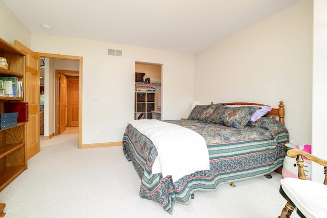 bedroom featuring light colored carpet and baseboards