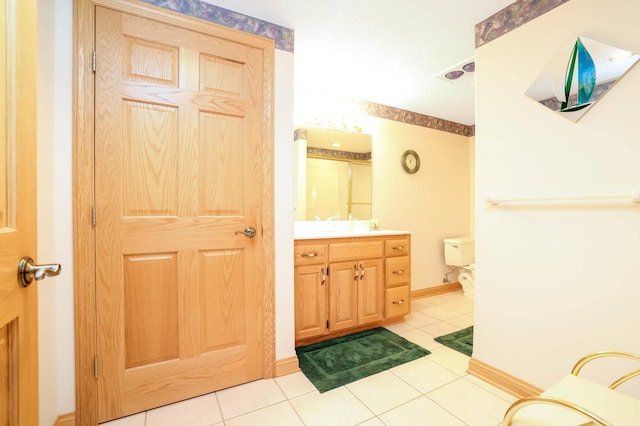 bathroom featuring tile patterned floors, vanity, and toilet