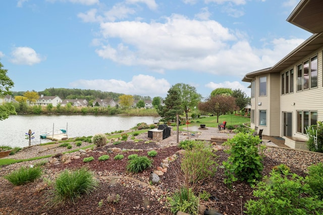view of yard featuring a water view and a patio area
