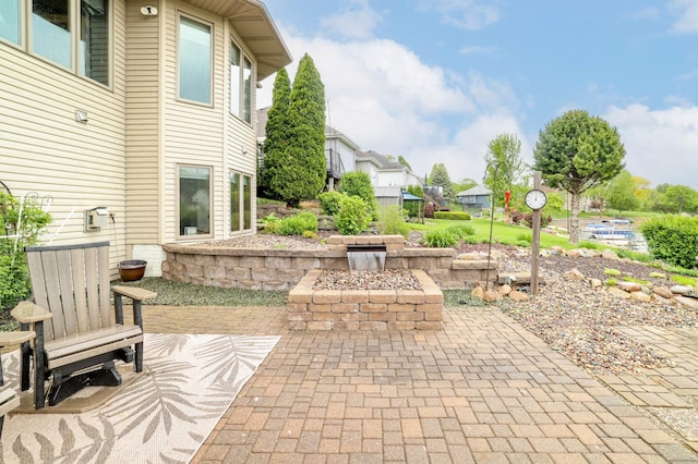 view of patio / terrace with a fire pit and a residential view