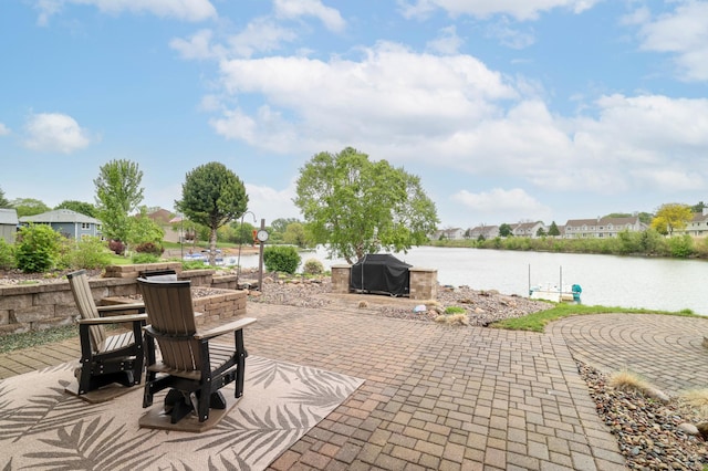 view of patio with a water view and a residential view