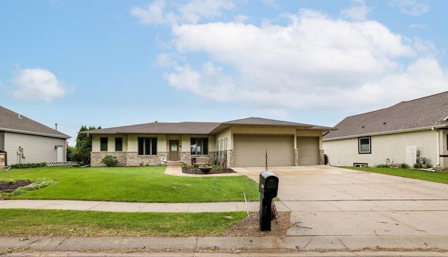view of front of house with a garage, concrete driveway, a front lawn, and stone siding