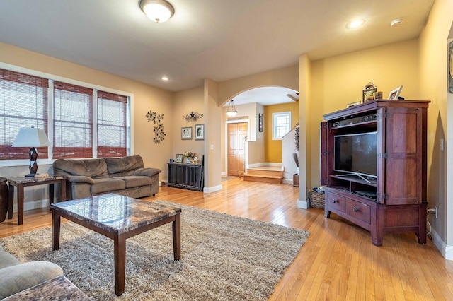 29560 204th Ave, Elizabeth Twp, MN 56537 - living area with arched walkways, baseboards, light wood finished floors, and recessed lighting