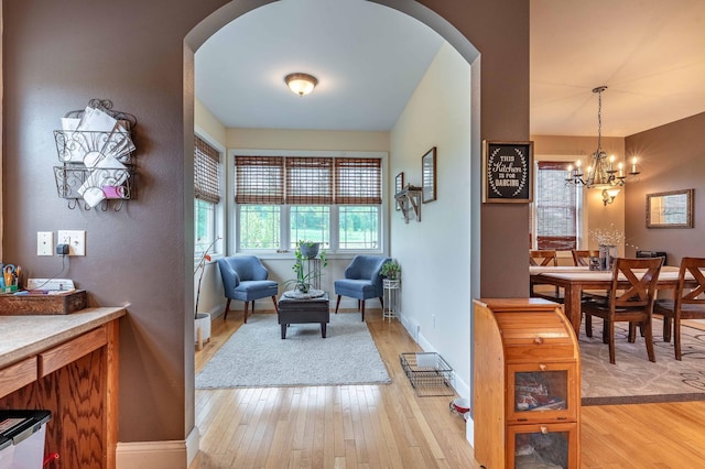 29560 204th Ave, Elizabeth Twp, MN 56537 - dining area with arched walkways, light wood-style flooring, and baseboards