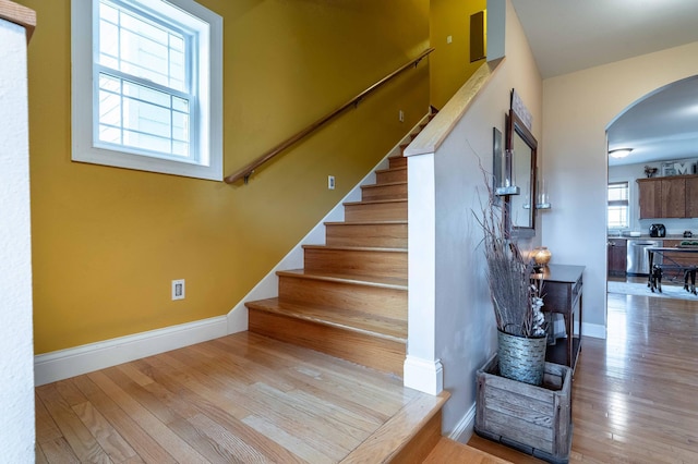 29560 204th Ave, Elizabeth Twp, MN 56537 - stairs with arched walkways, hardwood / wood-style floors, and baseboards