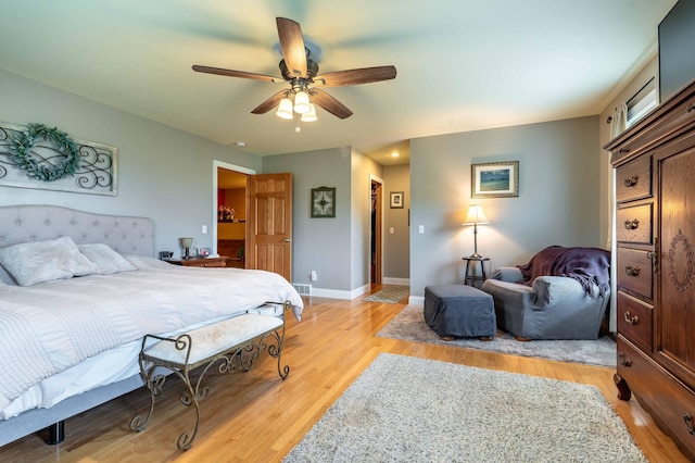 29560 204th Ave, Elizabeth Twp, MN 56537 - bedroom with light wood-style flooring, a ceiling fan, and baseboards
