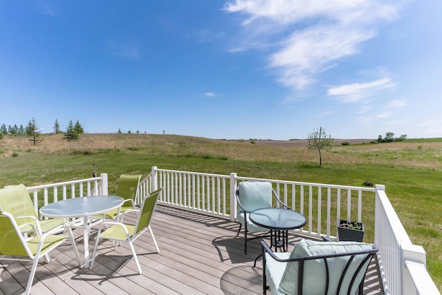 29560 204th Ave, Elizabeth Twp, MN 56537 - deck featuring outdoor dining area, a rural view, and a lawn