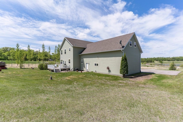 29560 204th Ave, Elizabeth Twp, MN 56537 - view of side of property featuring a wooden deck, a lawn, and a shingled roof