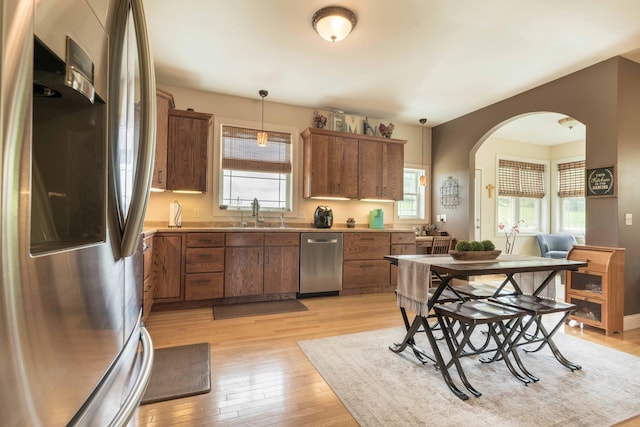 29560 204th Ave, Elizabeth Twp, MN 56537 - kitchen featuring appliances with stainless steel finishes, light wood finished floors, a sink, and brown cabinets