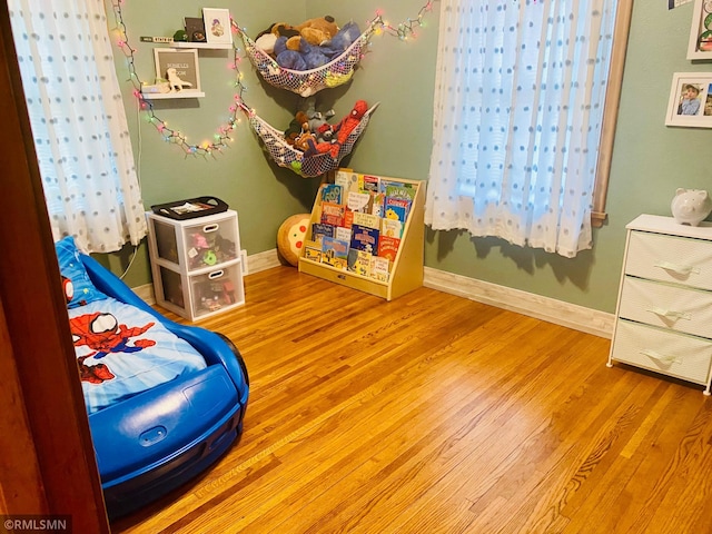 bedroom featuring wood finished floors and baseboards