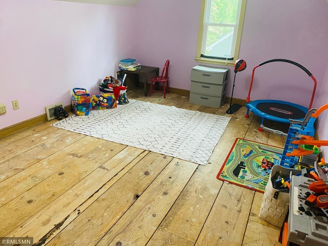 rec room featuring hardwood / wood-style floors and baseboards