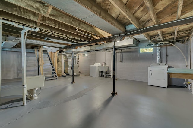 basement with washer / dryer, heating unit, stairs, and a sink