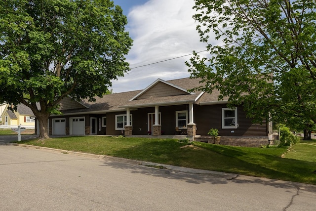 380 7th St SE, Chatfield, MN 55923 - view of front of home with an attached garage, a front lawn, covered porch, and a shingled roof