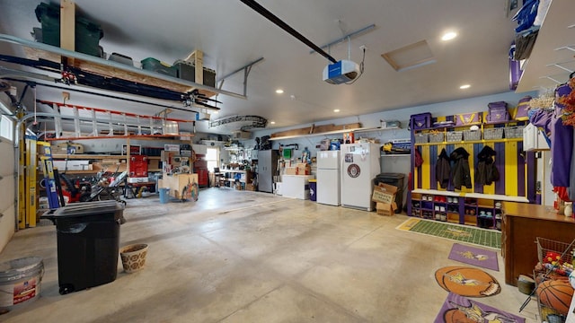 380 7th St SE, Chatfield, MN 55923 - garage featuring freestanding refrigerator, a garage door opener, and recessed lighting