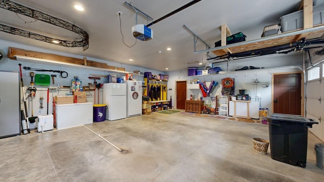 380 7th St SE, Chatfield, MN 55923 - garage featuring freestanding refrigerator, a garage door opener, and recessed lighting