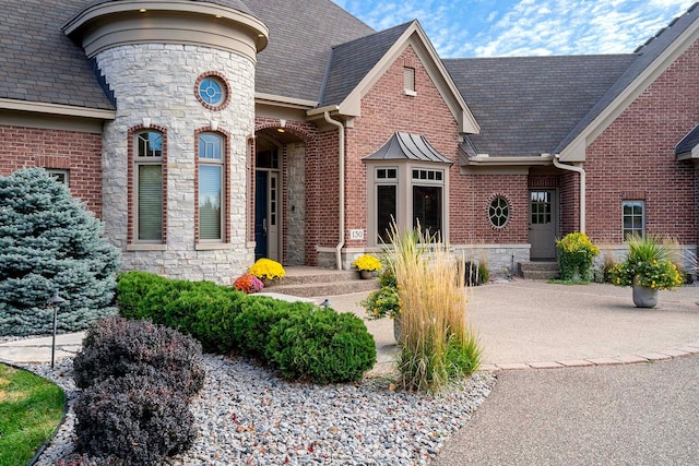 130 Bergamot Dr, Medina, MN 55340 - view of front of home featuring stone siding, brick siding, and a high end roof