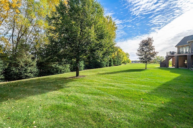 130 Bergamot Dr, Medina, MN 55340 - view of green lawn featuring stairway and a deck