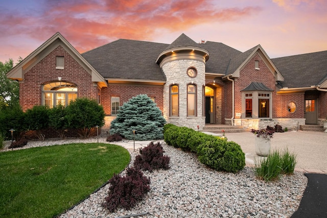 130 Bergamot Dr, Medina, MN 55340 - french country style house featuring brick siding, stone siding, and a front lawn