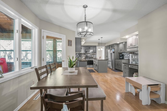 14994 Crane St NW, Andover, MN 55304 - dining space with a chandelier and light wood-type flooring