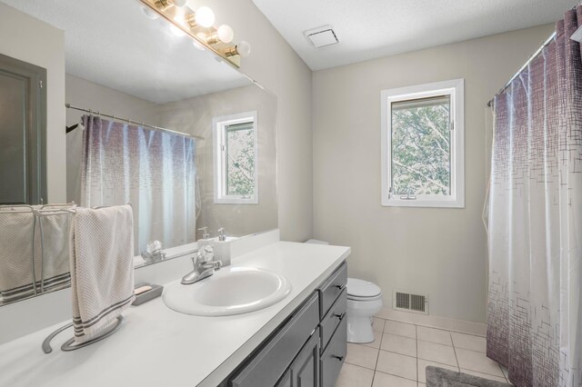 14994 Crane St NW, Andover, MN 55304 - full bath featuring plenty of natural light, vanity, tile patterned floors, and a shower with shower curtain